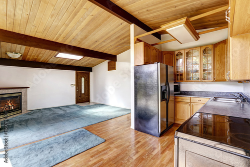 Empty living room with fireplace and hardwood floor