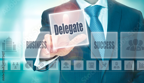 Tableau sur toile A businessman selecting a Delegate Concept button on a clear screen