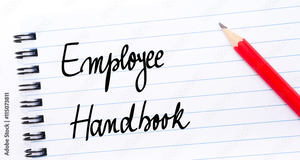 Employee Handbook written on notebook page Employee Handbook written on notebook page