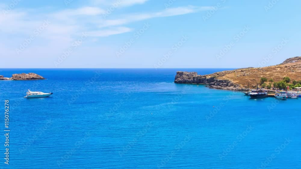 Greece. Rhodes. Top view on sea bay near town of Lindos. Wakeboarding. Greece. Rhodes. Top view on sea bay near town of Lindos. Wakeboarding.