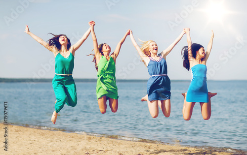 girls jumping on the beach