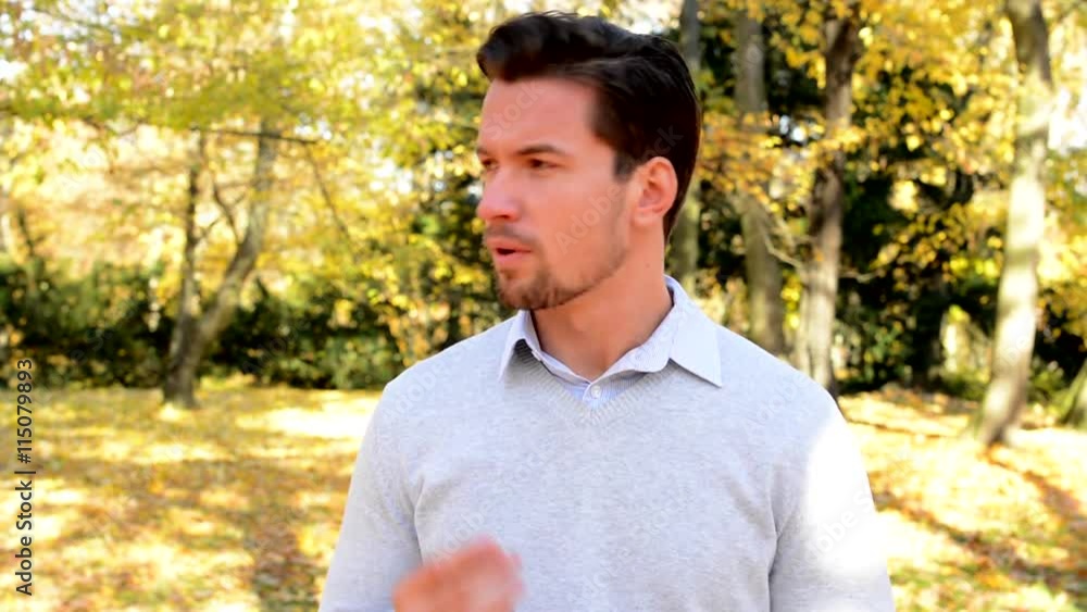 Young man stands in the woods and talks about something Young man stands in the woods and talks about something