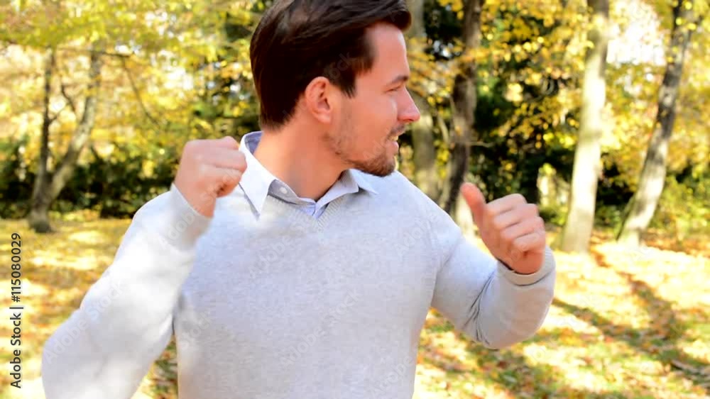 Young happy man cheerfully dances in the woods Young happy man cheerfully dances in the woods