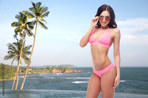 happy woman in sunglasses and bikini on beach