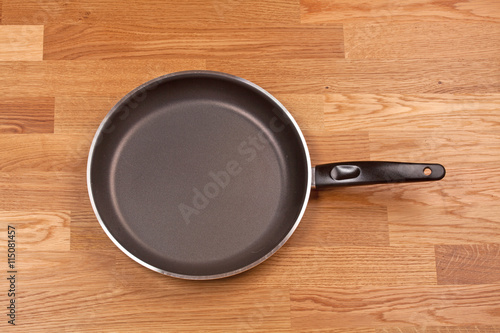 Empty pan with handle on wood table
