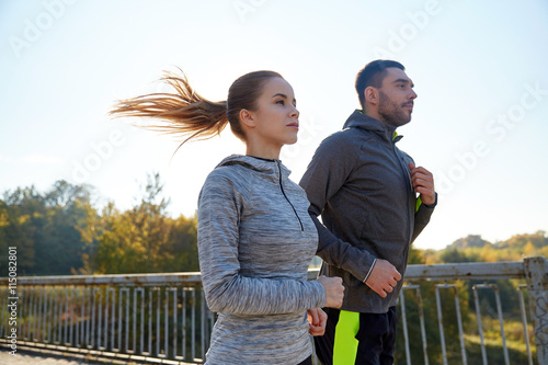happy couple running outdoors