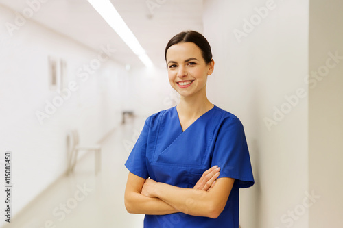 happy doctor or nurse at hospital corridor