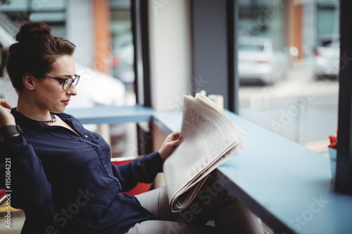 Woman reading newspaper photo
