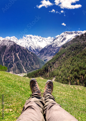Hiking boots in the mountains. Resting time and travel concept