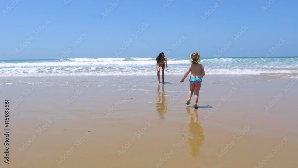 slow motion two years old blonde baby with blue and red swimsuit running towards woman at beach seaside in Spain Europe
slow motion two years old blonde baby with blue and red swimsuit running towards woman at beach seaside in Spain Europe