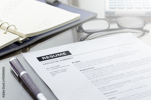 Resume information, pen, digital tablet, notebook, and glasses.