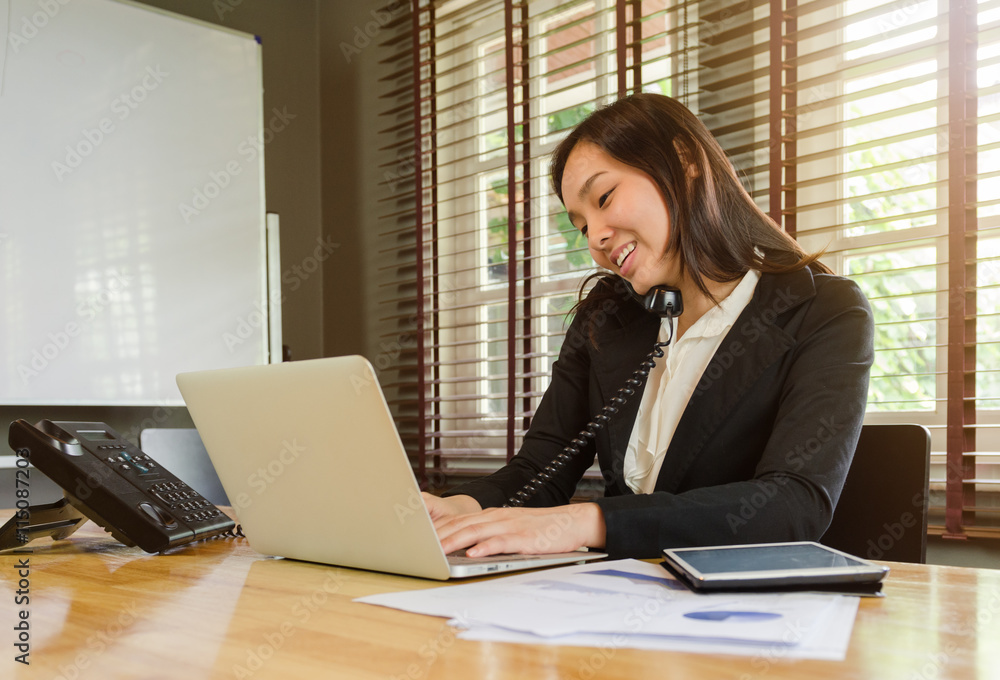 woman working in office and talking telephone and smiling woman working in office and talking telephone and smiling