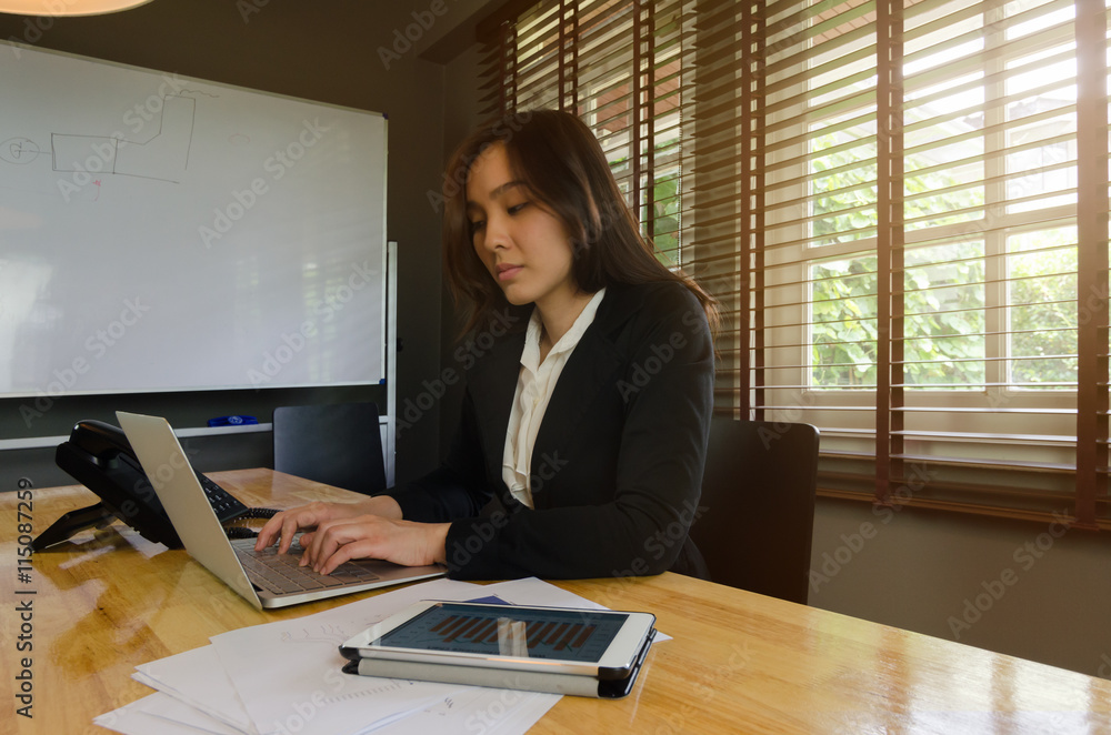 Business woman working with laptop in office Business woman working with laptop in office