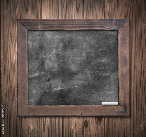 Teacher day concept: Blank old wooden blackboard or dirty slate board with white chalk.