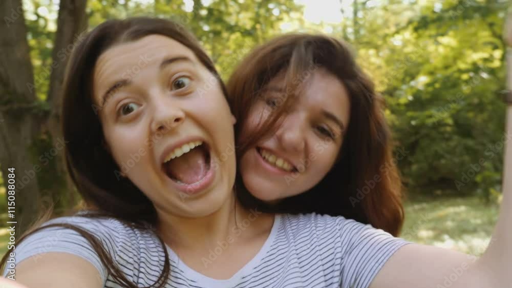 Beautiful young women taking selfie in the park Beautiful young women taking selfie in the park
