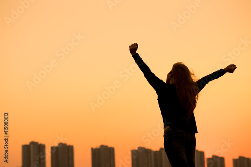 silhouette success woman hands up