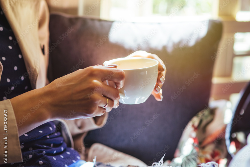 Woman drinking tea at a meeting with friends in the early morning. Woman drinking tea at a meeting with friends in the early morning.