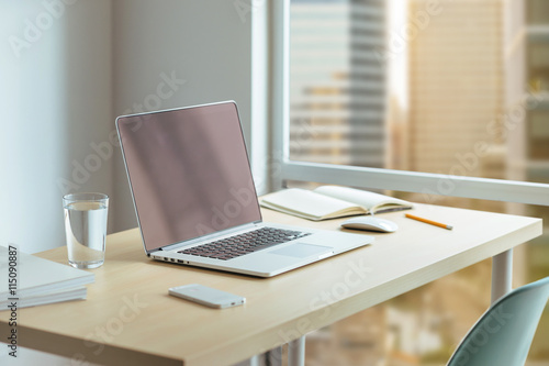Wallpaper Mural Desktop manager in a large company, Wooden desk with modern laptop, glass of water, modern cell phone, notebook. Desktop with a view of downtown, Sunrise, Shallow DOF. Torontodigital.ca