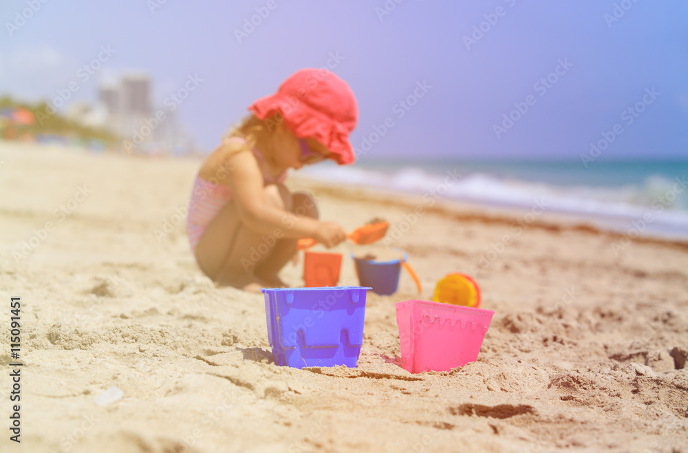 kids toys and little girl building sandcastle kids toys and little girl building sandcastle