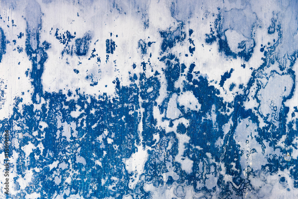 Wall with peeling plaster blue color.