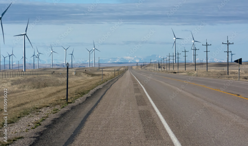 Fototapeta premium Road running Spinning wind turbines