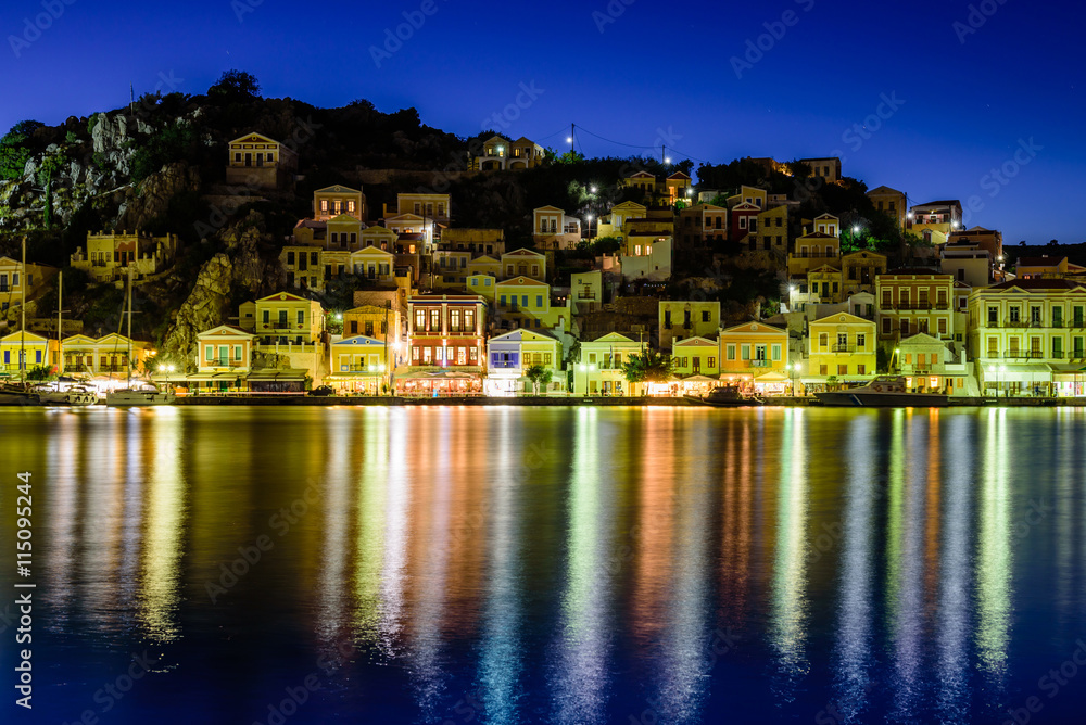 the scenic waterfront with colourful houses of Symi, night view, Symi island, Dodecanese, Greece.