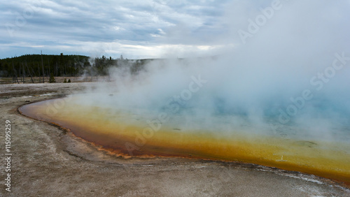 Blowing steam from geyser pool