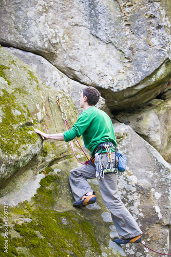 A rock climber climbs up the mountain.