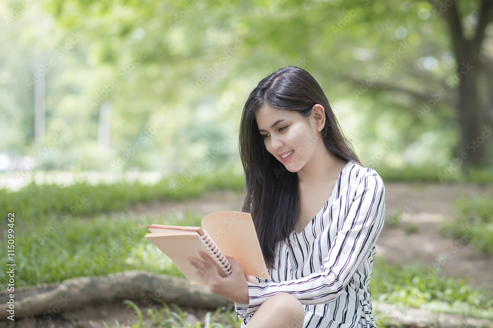 Attractive woman reading a book in the park Attractive woman reading a book in the park