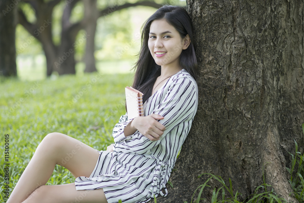 Attractive woman reading a book in the park Attractive woman reading a book in the park