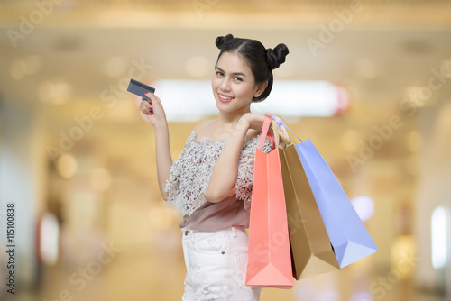 Attractive shopper woman holding shopping bags with Credit Card