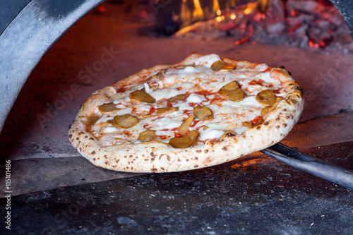 massive oven for pizza on firewood with pizza photo