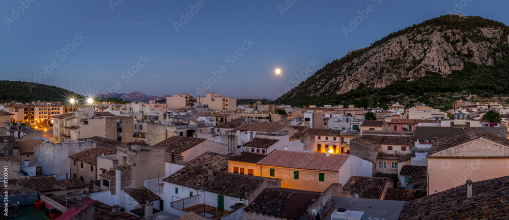 Evening shot with moon over Spanish town