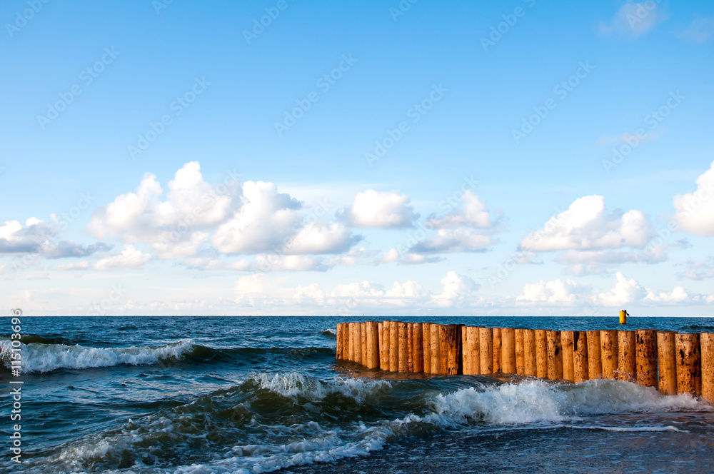 Breakwater on sea and blue sky