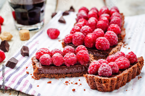 chocolate tart with chocolate filling and fresh raspberries