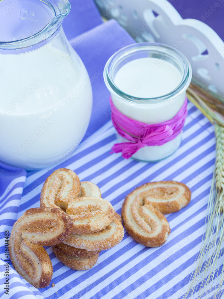 milk carafe and cookies on a table purple striped napkin milk carafe and cookies on a table purple striped napkin