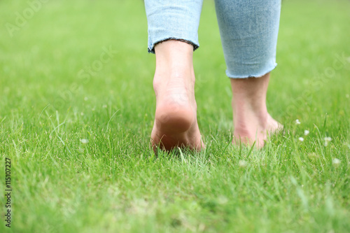 Woman legs on green grass