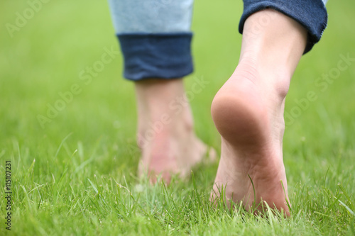 Woman legs on green grass