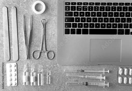 Medical tools set with laptop on gray background photo