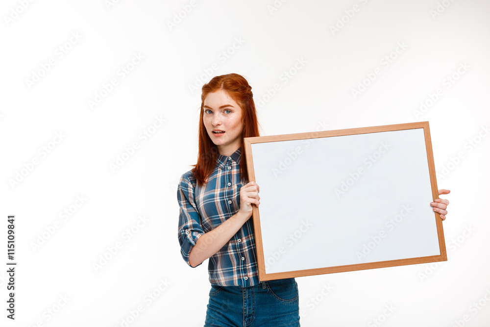 Portrait of beautiful ginger girl with whiteboard over white background. Portrait of beautiful ginger girl with whiteboard over white background.