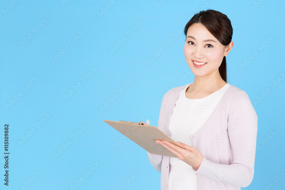 Obraz premium portrait of asian nurse isolated on blue background