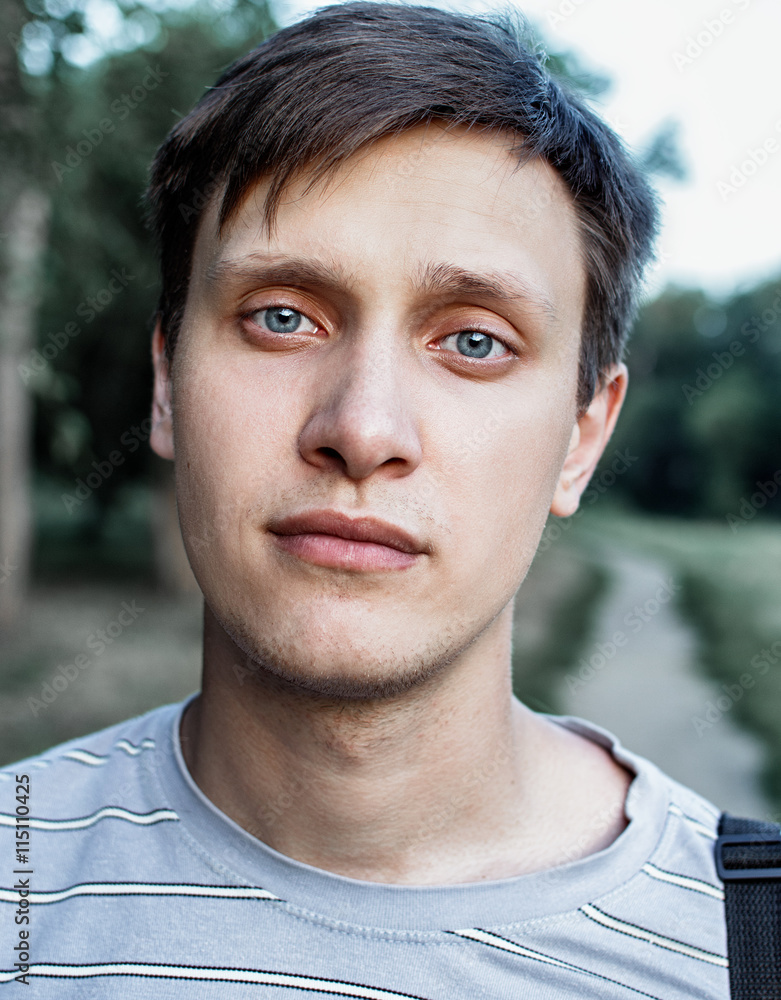 portrait of a young blue eyed men in the Park portrait of a young blue eyed men in the Park
