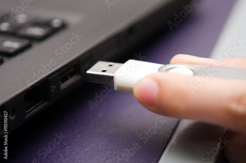 USB stick or USB thumb drive with virus plug in to laptop comput