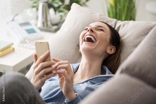 Woman on the couch using a smartphone
