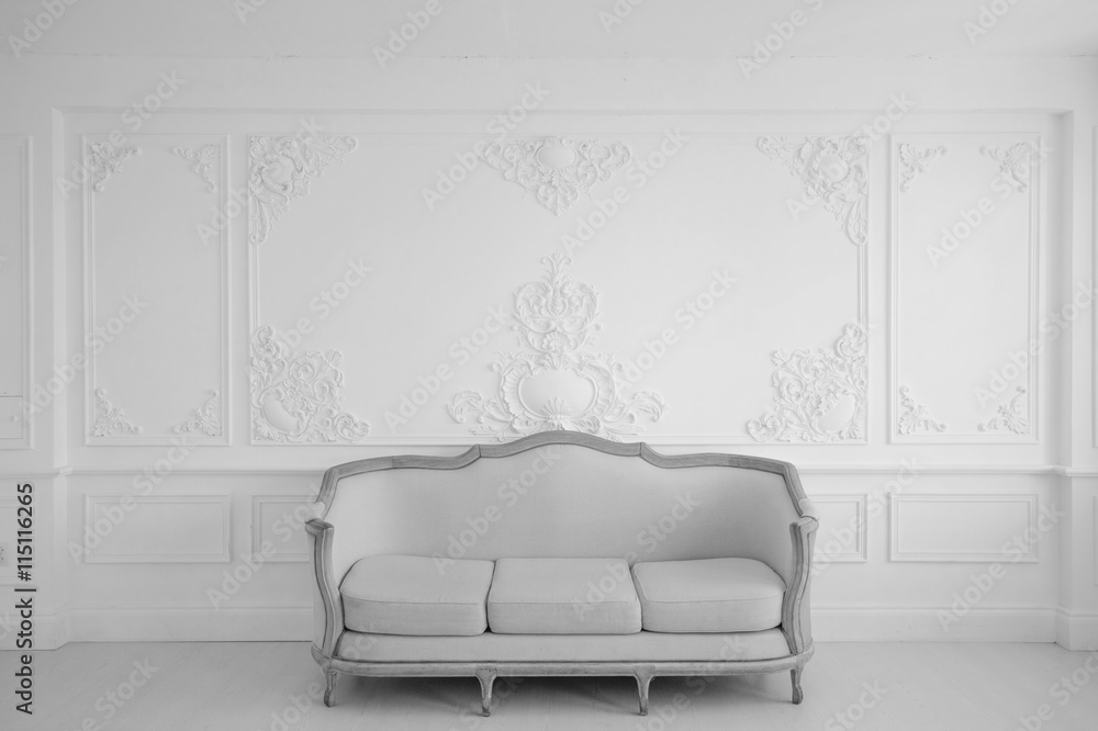 Living room with antique stylish light sofa on luxury white wall design bas-relief  stucco mouldings roccoco elements. Black and white photo. Stock Photo |  Adobe Stock