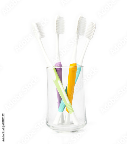 toothbrush in transparent glass on white background