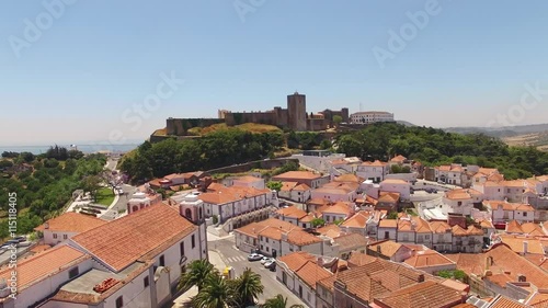 Palmela Castle on the mountain in the background of the city aerial view