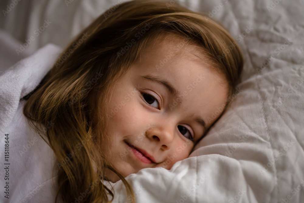 little girl falls asleep in bed on white pillow little girl falls asleep in bed on white pillow