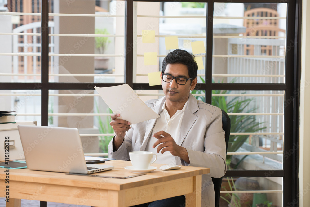 stress looking indian business male at office stress looking indian business male at office