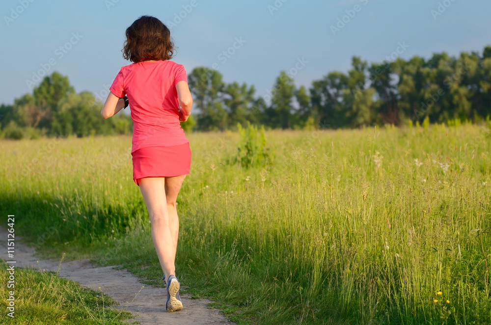 Woman runner jogging on trail outdoors, spring running and exercising
Woman runner jogging on trail outdoors, spring running and exercising